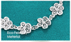 Bracelet en métal argenté en filigrane
