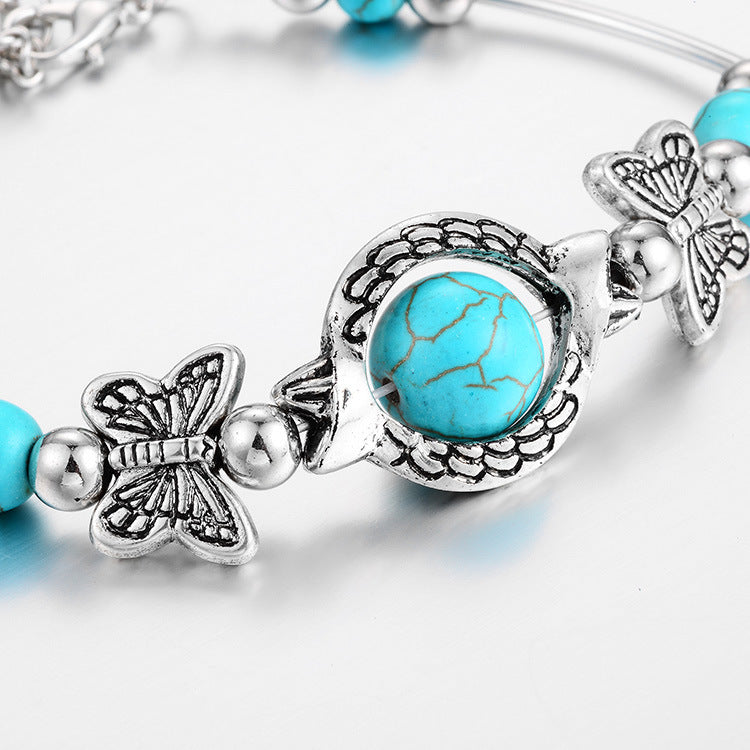 Bracelet avec des papillons et des perles turquoises