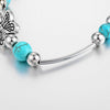 Bracelet avec des papillons et des perles turquoises