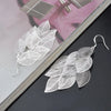 Boucles d'oreilles en filigrane superposées avec des feuilles