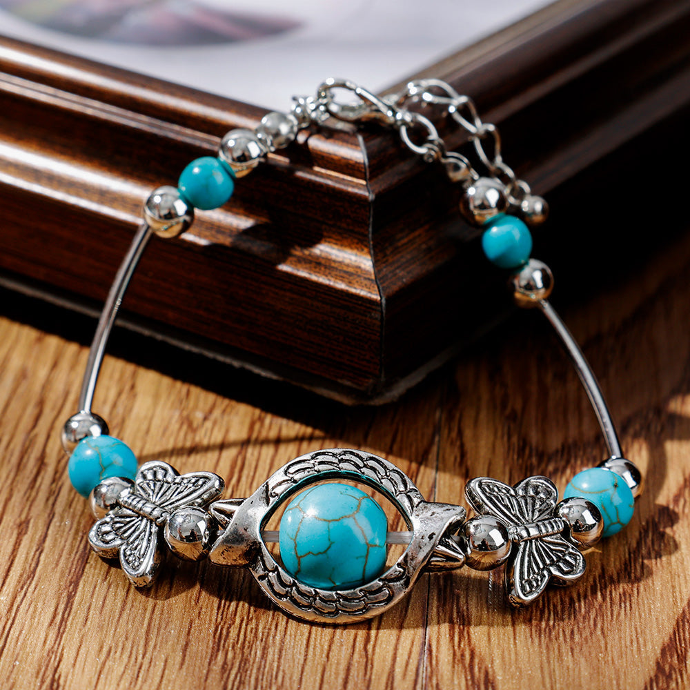 Bracelet avec des papillons et des perles turquoises