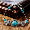 Bracelet avec des papillons et des perles turquoises