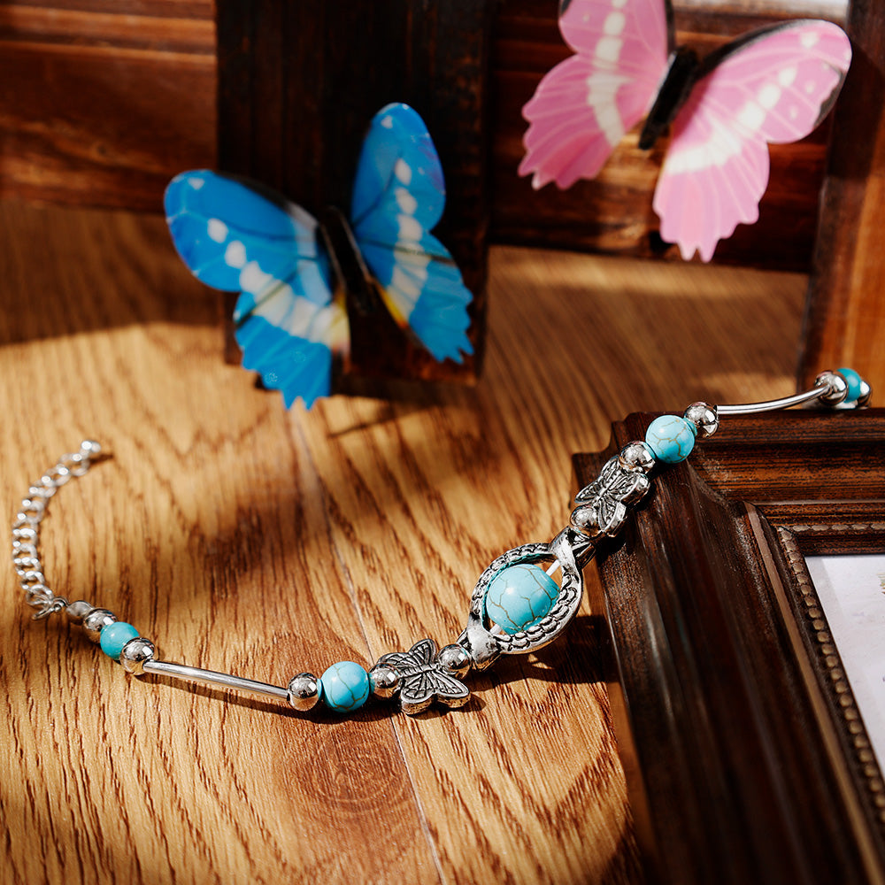 Bracelet avec des papillons et des perles turquoises