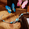 Bracelet avec des papillons et des perles turquoises